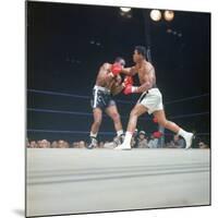 Cassius Clay, aka Muhammad Ali Throwing Famous "Phantom Punch"-George Silk-Mounted Premium Photographic Print