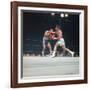 Cassius Clay, aka Muhammad Ali Throwing Famous "Phantom Punch"-George Silk-Framed Premium Photographic Print