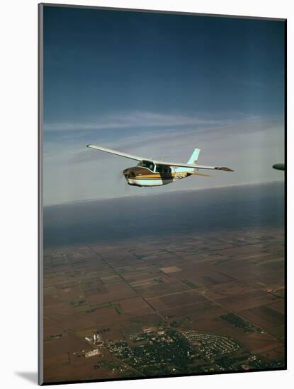 Cessna 210 Centurion Flying-null-Mounted Photographic Print