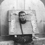 Chinese Prisoner in the Cangue Placarded with the Record of His Crime, China, 1902-CH Graves-Photographic Print