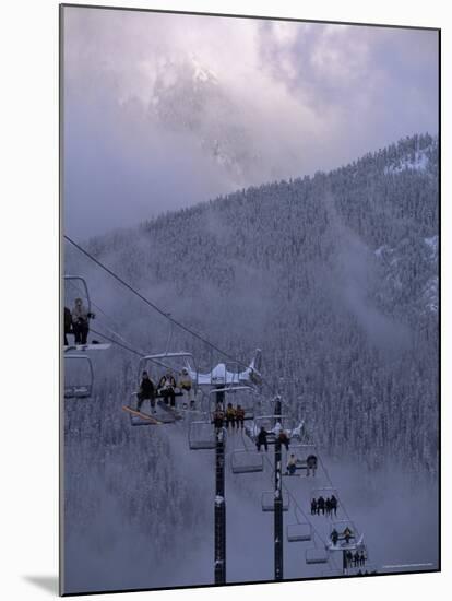 Chair Lift Filled with Skiers and Snowboarders, Washington State, USA-Aaron McCoy-Mounted Photographic Print