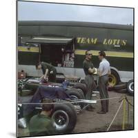 Chapman and Clark Outside the Lotus Team Bus, French Grand Prix, Clermont-Ferrand, France, 1965-null-Mounted Photographic Print