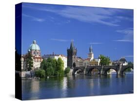 Charles Bridge over the Vltava River and City Skyline of Prague, Czech Republic, Europe-Nigel Francis-Stretched Canvas