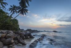 Sunrise at a Secluded Lagoon with Rocks and Palm Trees Framing the View-Charlie-Photographic Print