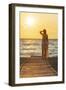 Charming woman contemplating the sea at sunset standing on Matala beach, Crete-Roberto Moiola-Framed Photographic Print