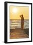 Charming woman contemplating the sea at sunset standing on Matala beach, Crete-Roberto Moiola-Framed Photographic Print