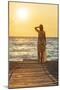 Charming woman contemplating the sea at sunset standing on Matala beach, Crete-Roberto Moiola-Mounted Photographic Print