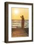 Charming woman contemplating the sea at sunset standing on Matala beach, Crete-Roberto Moiola-Framed Photographic Print