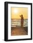 Charming woman contemplating the sea at sunset standing on Matala beach, Crete-Roberto Moiola-Framed Photographic Print