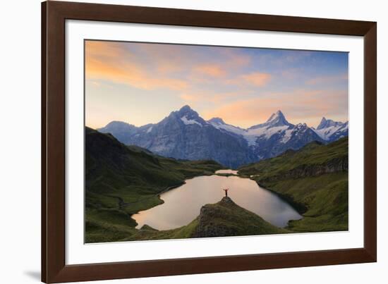 Cheerful hiker admiring Wetterhorn, Schreckhorn and Finsteraarhorn from Bachalpsee at dawn-Roberto Moiola-Framed Photographic Print