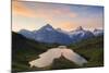 Cheerful hiker admiring Wetterhorn, Schreckhorn and Finsteraarhorn from Bachalpsee at dawn-Roberto Moiola-Mounted Photographic Print