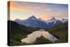 Cheerful hiker admiring Wetterhorn, Schreckhorn and Finsteraarhorn from Bachalpsee at dawn-Roberto Moiola-Stretched Canvas