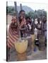 Cheerful Young Girls Pound Corn Outside Families' Homes Near Monkey Bay, South End of Lake Malawi-Nigel Pavitt-Stretched Canvas