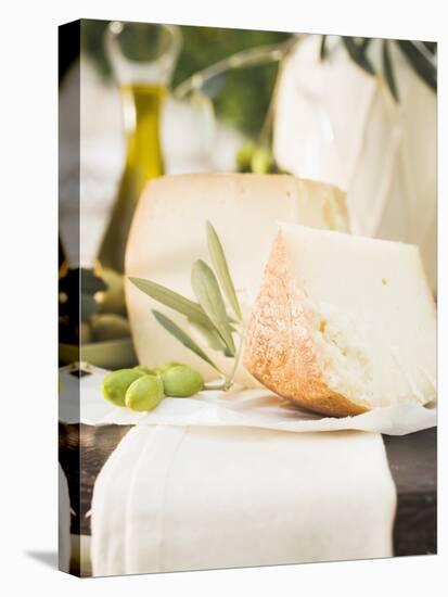 Cheese, Green Olives and Olive Oil on Table Out of Doors-null-Stretched Canvas