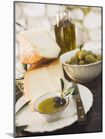 Cheese, Olives and Olive Oil on Table Out of Doors-null-Mounted Photographic Print