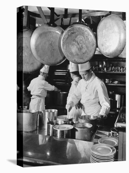 Chefs Cooking in a Restaurant Kitchen at Radio City-Bernard Hoffman-Stretched Canvas