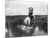 Cheyenne Indian, Wearing Headdress, on Horseback Photograph-Lantern Press-Mounted Art Print