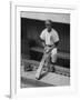 Chicago Cub's Ernie Banks, Stooping in the Dug-Out Holding Two Bats Against Cincinnati Reds-John Dominis-Framed Premium Photographic Print