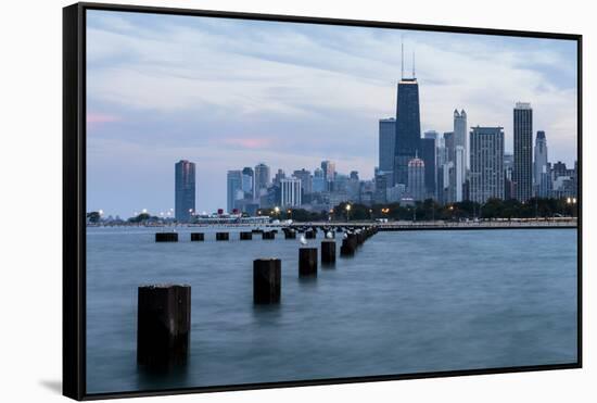 Chicago, Illinois, USA, Seagulls sit atop metal pylons in the waters of Lake Michigan.-Brent Bergherm-Framed Stretched Canvas