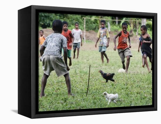 Chickens Run to Avoid a Soccer Game Played by Children from Lolovoli Village on the Island of Ambae-null-Framed Stretched Canvas