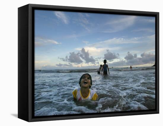 Child as She Plays in the Waves at a Beach in Port Blair, India-null-Framed Stretched Canvas