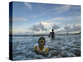 Child as She Plays in the Waves at a Beach in Port Blair, India-null-Stretched Canvas