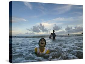 Child as She Plays in the Waves at a Beach in Port Blair, India-null-Stretched Canvas