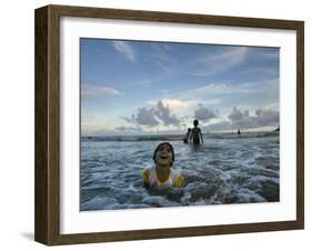 Child as She Plays in the Waves at a Beach in Port Blair, India-null-Framed Photographic Print