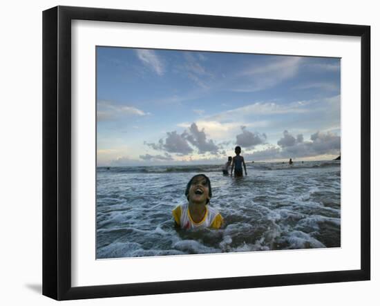 Child as She Plays in the Waves at a Beach in Port Blair, India-null-Framed Photographic Print