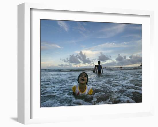 Child as She Plays in the Waves at a Beach in Port Blair, India-null-Framed Photographic Print