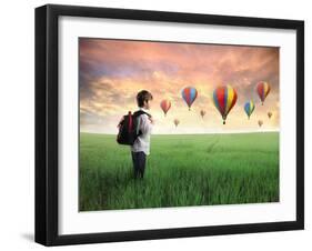 Child Carrying A Backpack Standing On A Green Meadow With Hot-Air Balloons In The Background-olly2-Framed Art Print