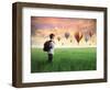 Child Carrying A Backpack Standing On A Green Meadow With Hot-Air Balloons In The Background-olly2-Framed Art Print