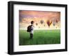 Child Carrying A Backpack Standing On A Green Meadow With Hot-Air Balloons In The Background-olly2-Framed Art Print