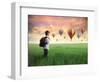 Child Carrying A Backpack Standing On A Green Meadow With Hot-Air Balloons In The Background-olly2-Framed Art Print