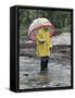 Child in Rain Gear with Umbrella Playing in Puddle.-Nora Hernandez-Framed Stretched Canvas