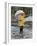 Child in Rain Gear with Umbrella Playing in Puddle.-Nora Hernandez-Framed Giclee Print