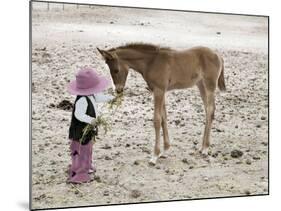 Child in Western Wear Feeding a Pony-Nora Hernandez-Mounted Giclee Print