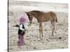 Child in Western Wear Feeding a Pony-Nora Hernandez-Stretched Canvas