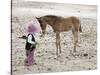 Child in Western Wear Feeding a Pony-Nora Hernandez-Stretched Canvas