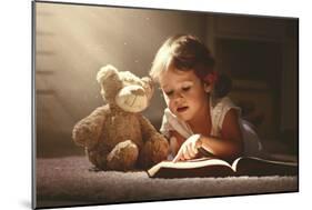 Child Little Girl Reading a Magic Book in the Dark Home with a Toy Teddy Bear-evgeny atamanenko-Mounted Photographic Print