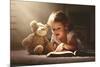 Child Little Girl Reading a Magic Book in the Dark Home with a Toy Teddy Bear-evgeny atamanenko-Mounted Photographic Print