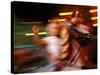 Child on Carousel at Grona Lund Amusement Park, Stockholm, Sweden-Nancy & Steve Ross-Stretched Canvas