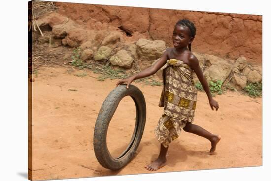 Child playing with a tyre, Tori, Benin-Godong-Stretched Canvas