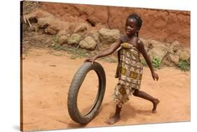 Child playing with a tyre, Tori, Benin-Godong-Stretched Canvas