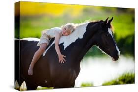 Child Sits On A Horse In Meadow Near Small River-Alexia Khruscheva-Stretched Canvas