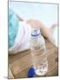 Child Sitting Beside Bottle of Water on Edge of Pool-null-Mounted Photographic Print