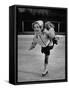 Child Skater Helen Ann Rousselle Holding Doll While Skating across the Ice-null-Framed Stretched Canvas