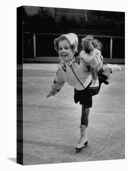 Child Skater Helen Ann Rousselle Holding Doll While Skating across the Ice-null-Stretched Canvas