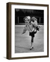 Child Skater Helen Ann Rousselle Holding Doll While Skating across the Ice-null-Framed Photographic Print