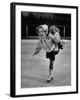 Child Skater Helen Ann Rousselle Holding Doll While Skating across the Ice-null-Framed Photographic Print